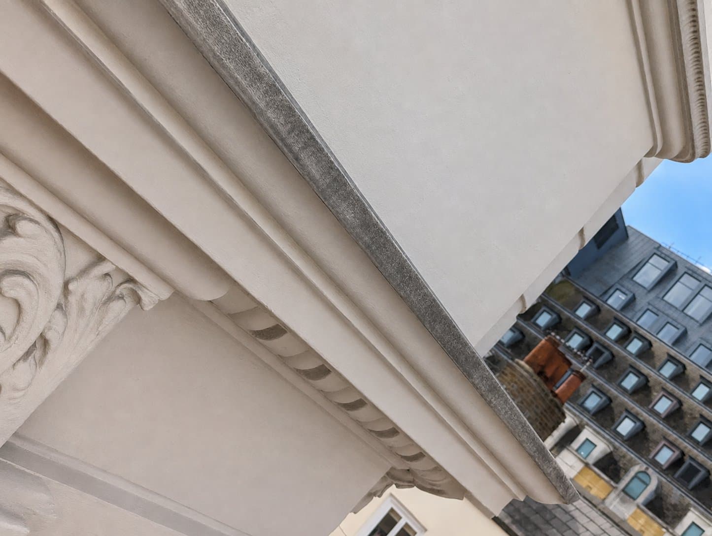 After: the same cornice run filled, made good and redecorated in cream