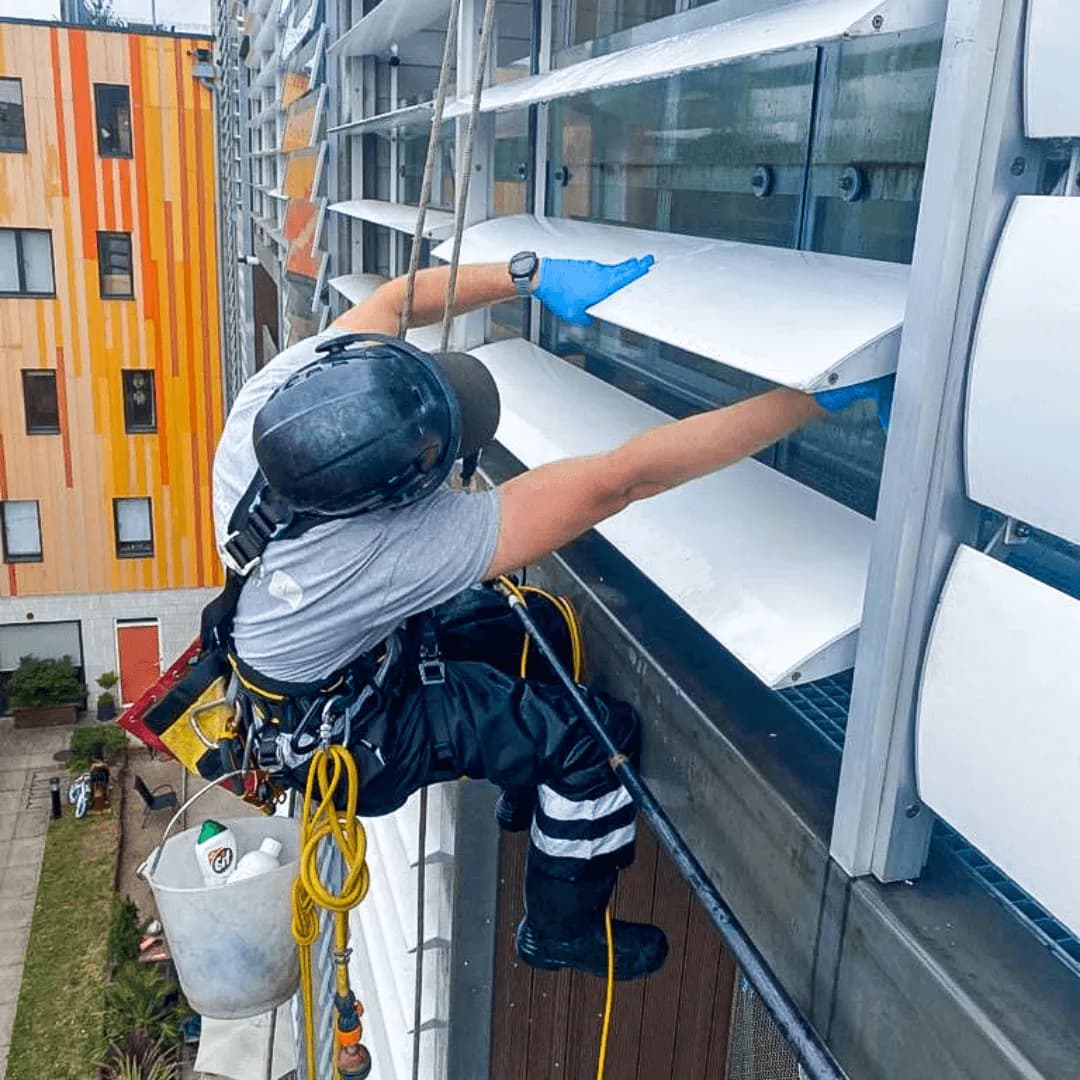 Rope access operative carrying out facade inspection works