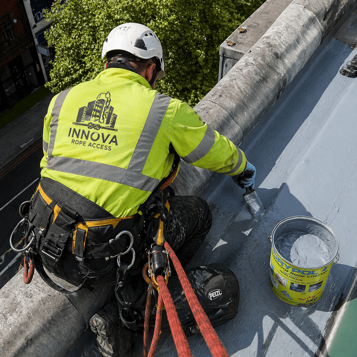 Innova operative carrying out painting and leak sealing works at roof level